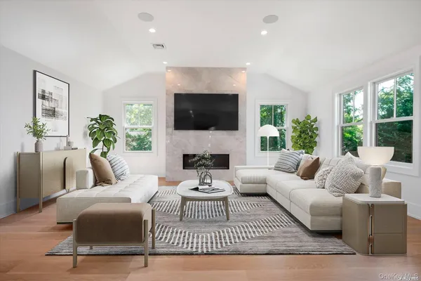 a living room with furniture a fireplace and a flat screen tv