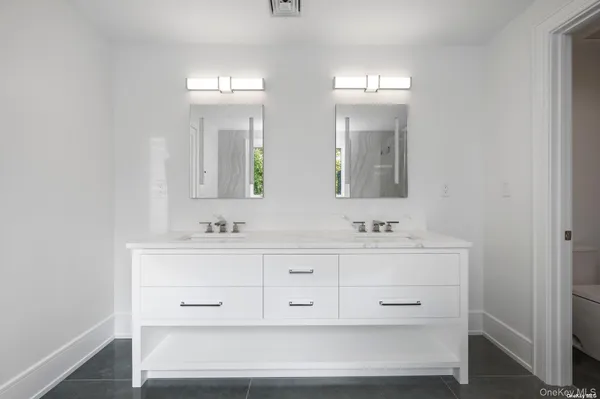 a bathroom with double vanity sink a mirror and vanity