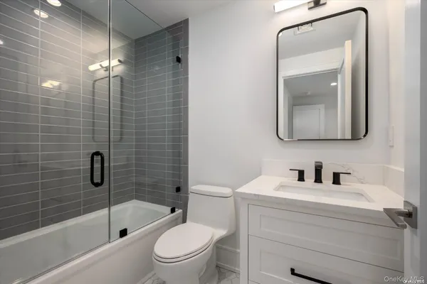 a bathroom with a toilet a sink a bath tub and shower