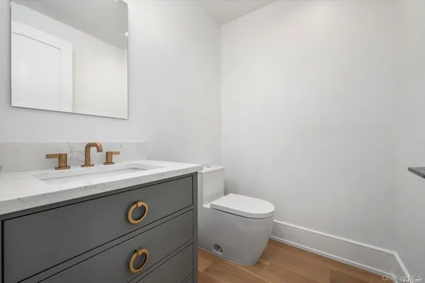 a view of bathroom with a sink toilet and a mirror
