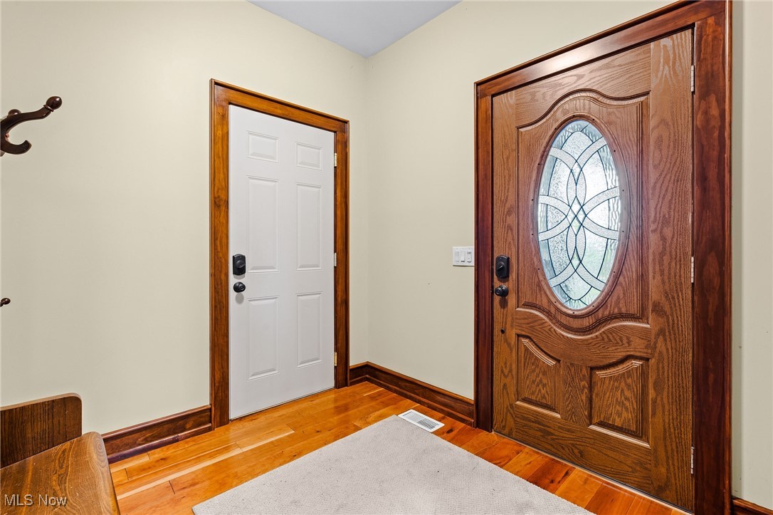 1238 Ridge Road Hinckley, OH 44233 - Photo 3 of 42 Entryway featuring hardwood / wood-style flooring and baseboards