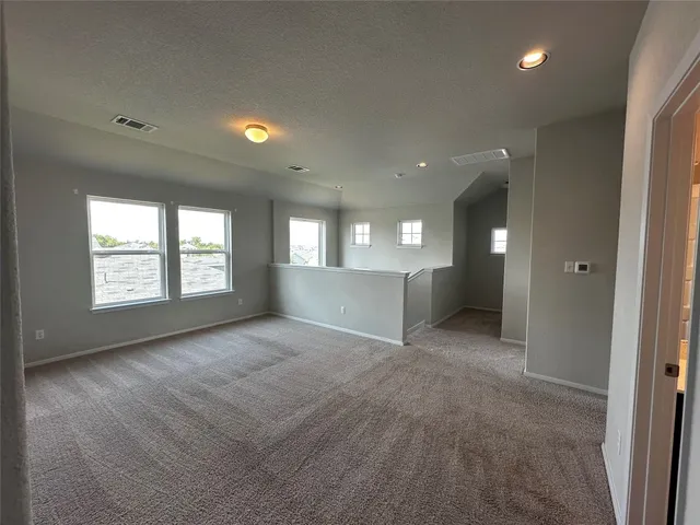 an empty room with windows and entrance