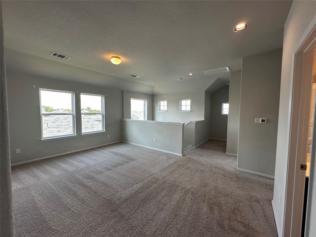 316 Insider Loop Elgin, TX 78621 - Photo 12 of 13 an empty room with windows and entrance
