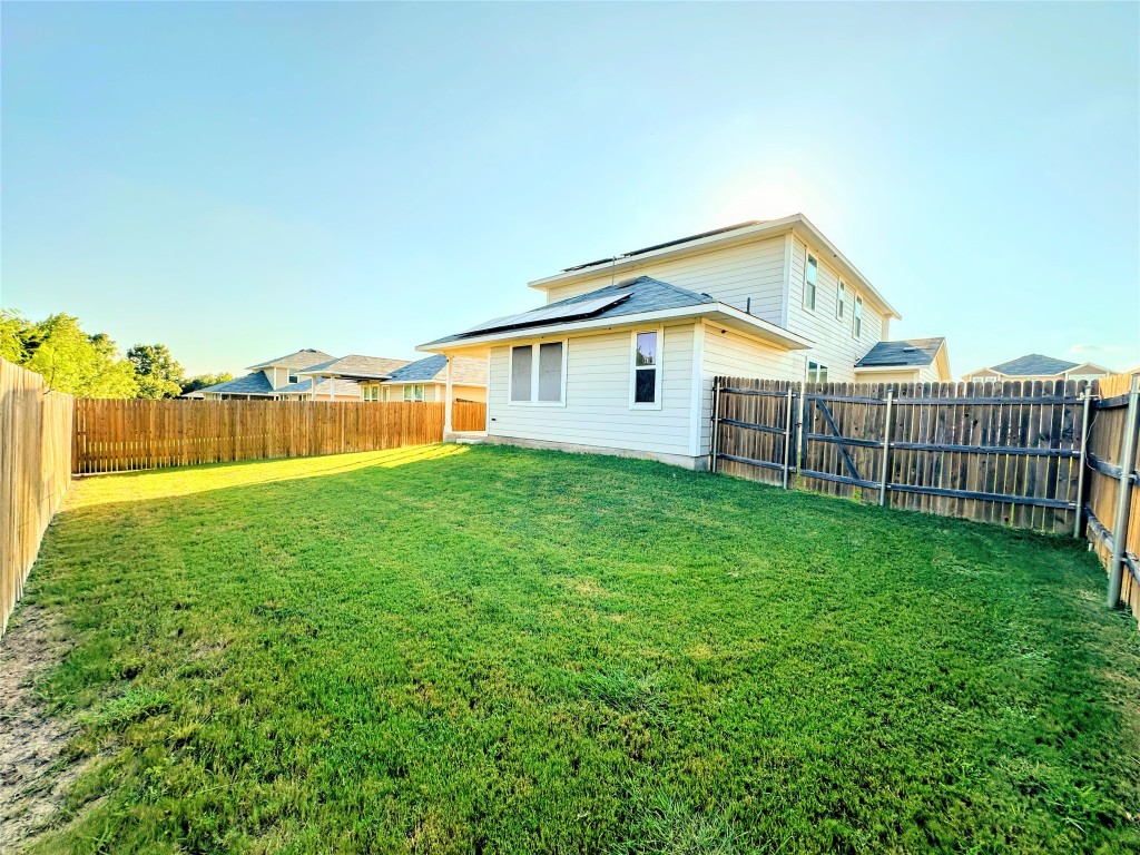 316 Insider Loop Elgin, TX 78621 - Photo 13 of 13 a view of a house with backyard and garden