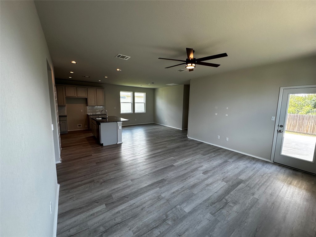 316 Insider Loop Elgin, TX 78621 - Photo 6 of 13 wooden floor in an empty room with a window