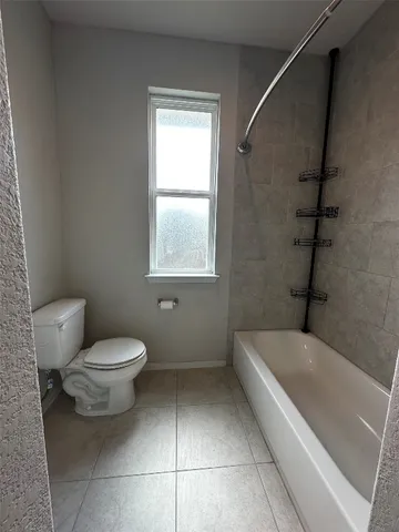 a bathroom with a toilet a sink and bathtub