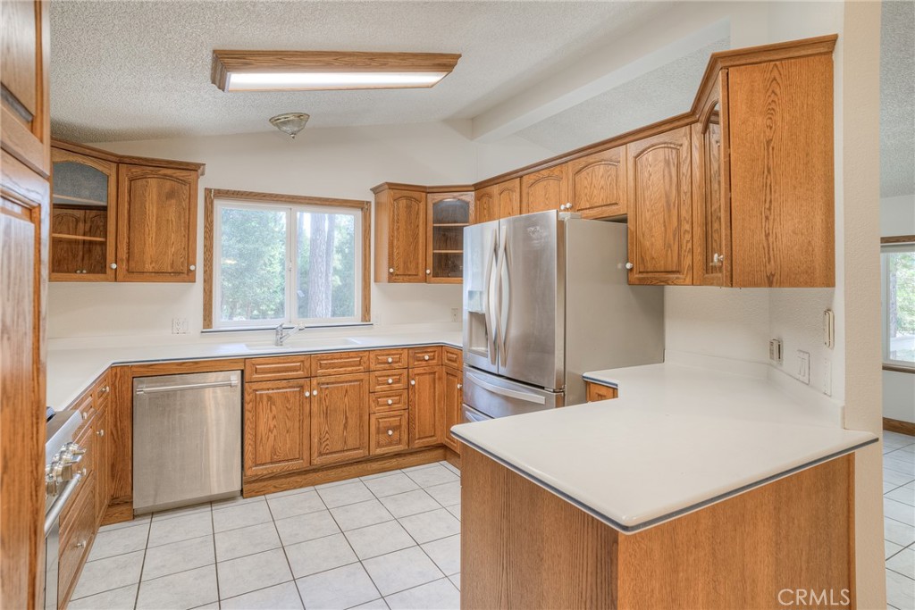 3635 Charqui Court Oroville, CA 95965 - Photo 19 of 75 a kitchen with stainless steel appliances a refrigerator sink and cabinets