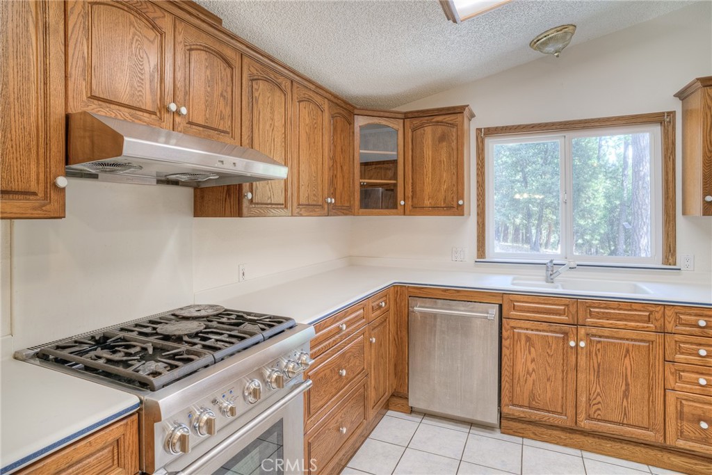 3635 Charqui Court Oroville, CA 95965 - Photo 20 of 75 a kitchen with granite countertop cabinets stainless steel appliances and a window