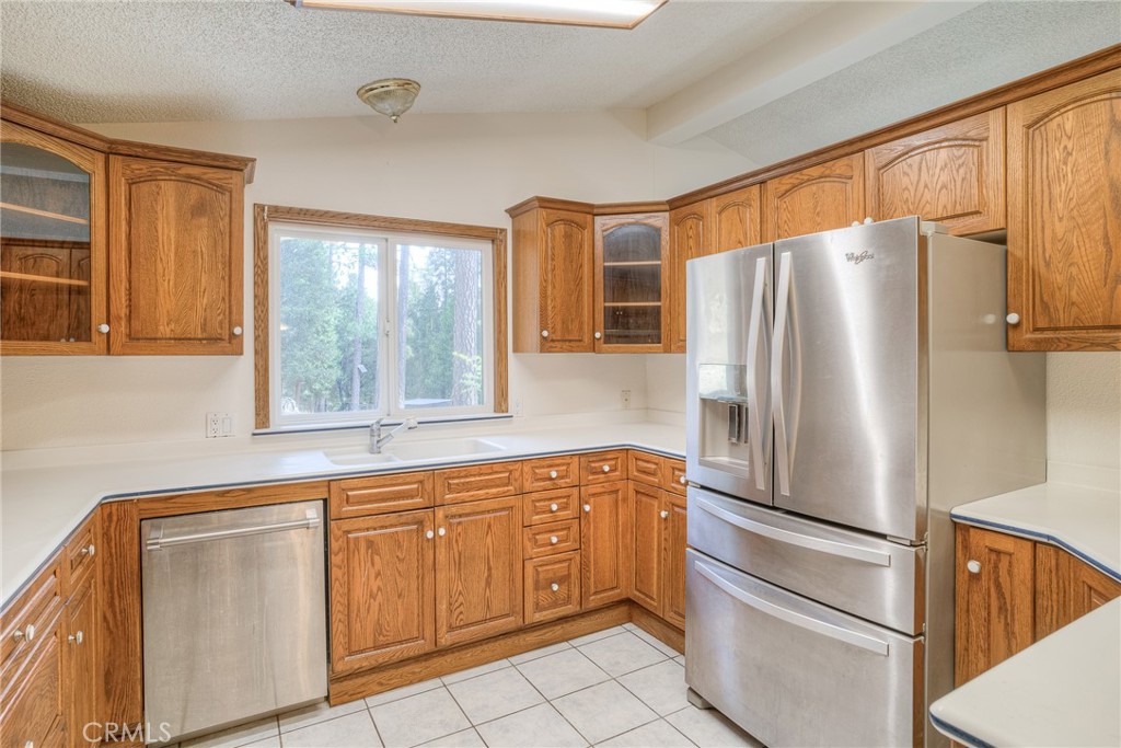 3635 Charqui Court Oroville, CA 95965 - Photo 21 of 75 a kitchen with stainless steel appliances a refrigerator sink and cabinets