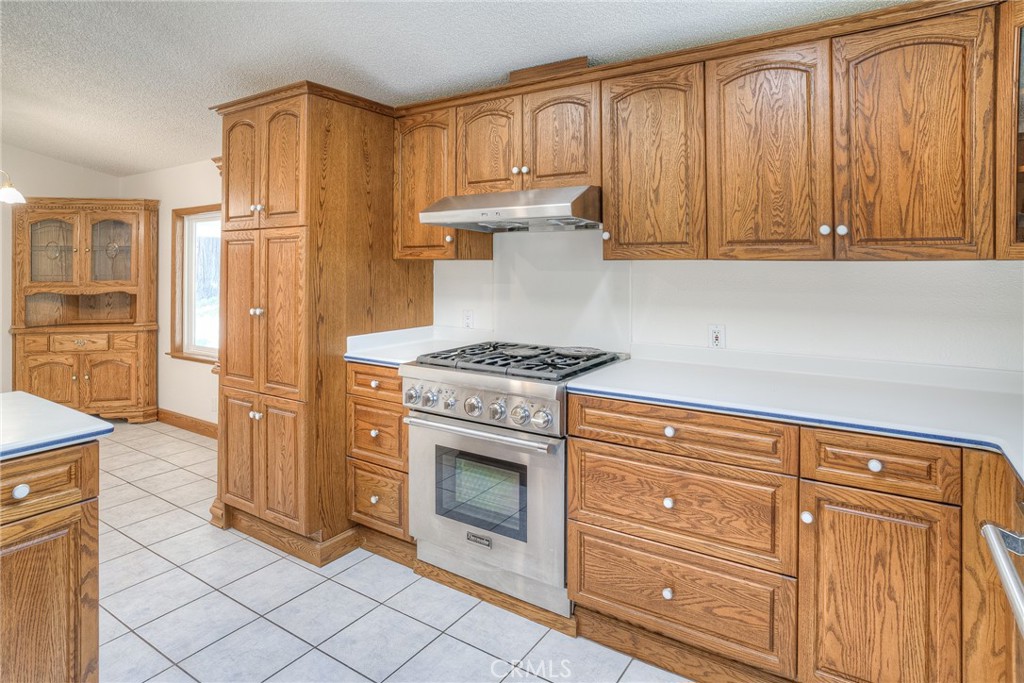 3635 Charqui Court Oroville, CA 95965 - Photo 23 of 75 a kitchen with granite countertop cabinets and steel stainless steel appliances