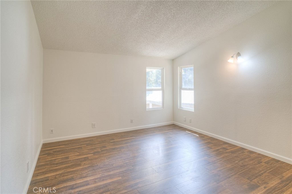 3635 Charqui Court Oroville, CA 95965 - Photo 29 of 75 a view of an empty room with wooden floor and window