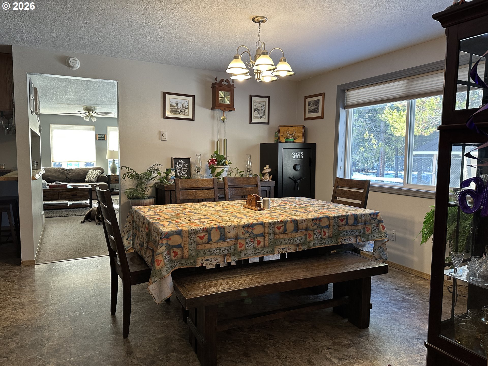 123977 Surveyor Road Crescent Lake, OR 97733 - Photo 16 of 46 a living room with a table chairs and a chandelier