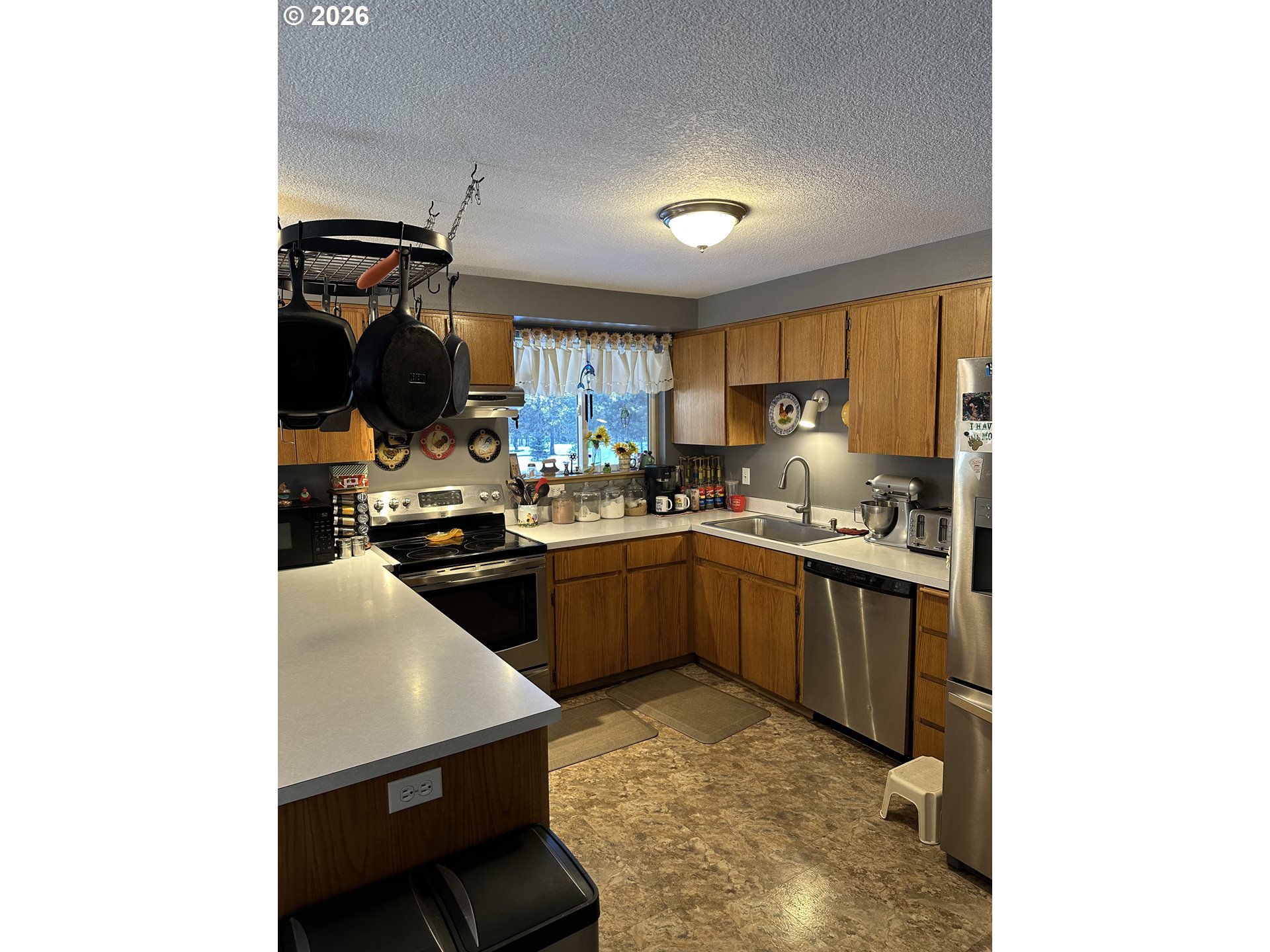 123977 Surveyor Road Crescent Lake, OR 97733 - Photo 18 of 46 a kitchen with a sink cabinets and stainless steel appliances