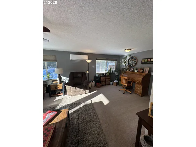 a living room with furniture and a dining table