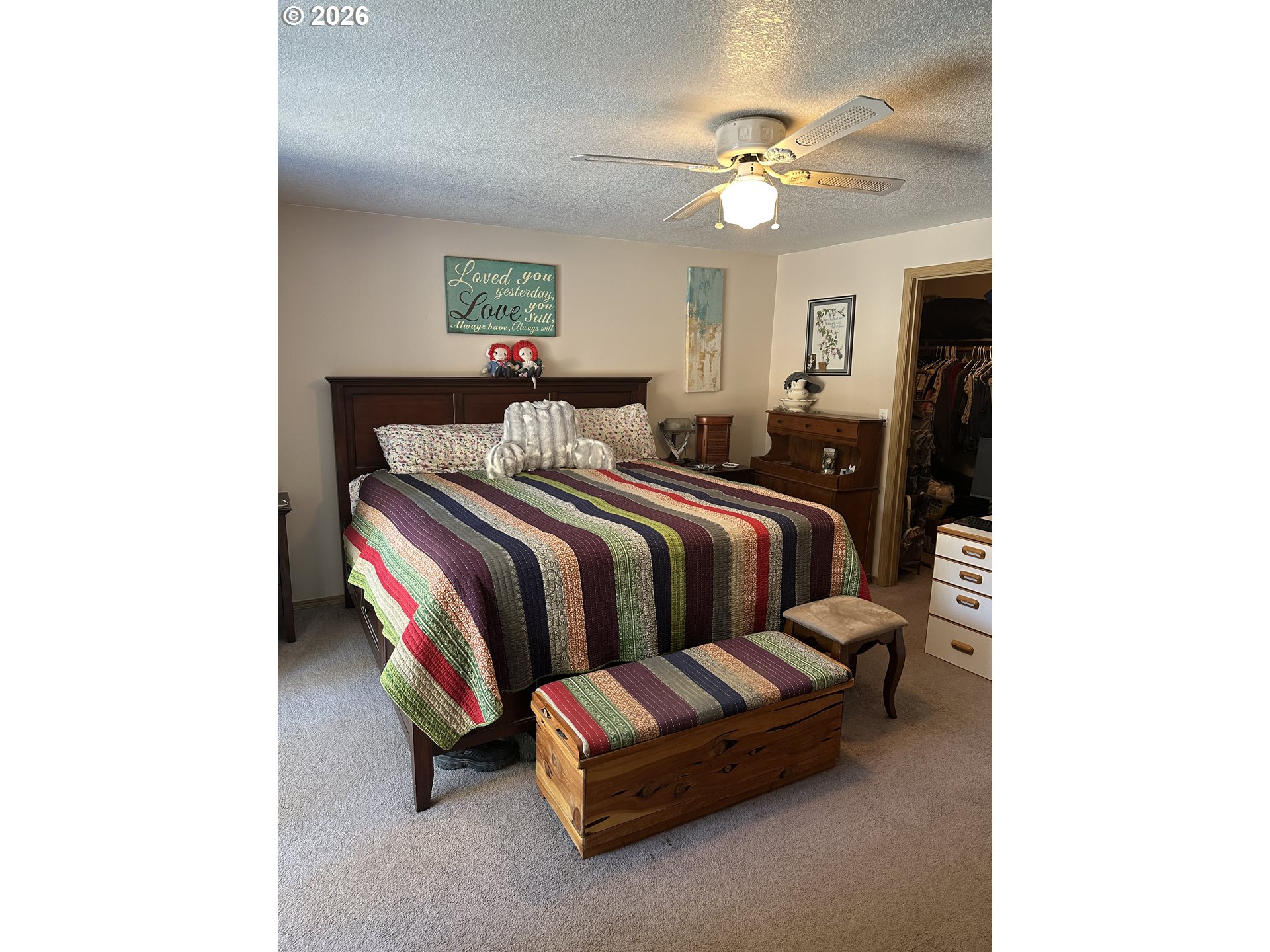 123977 Surveyor Road Crescent Lake, OR 97733 - Photo 37 of 46 a spacious bedroom with a bed and a ceiling fan