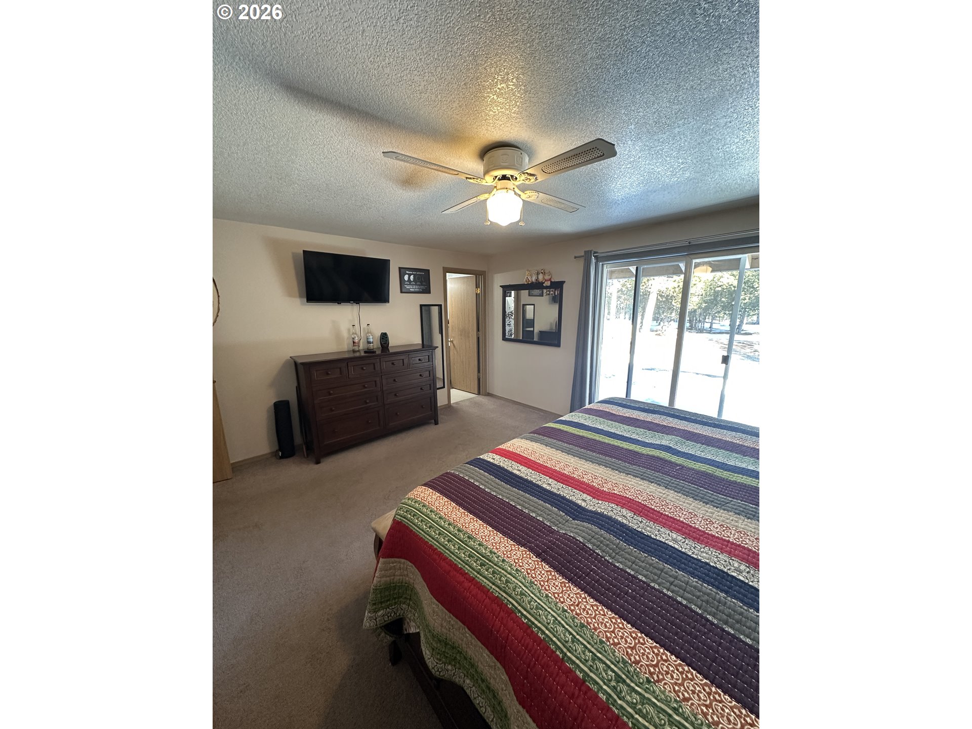 123977 Surveyor Road Crescent Lake, OR 97733 - Photo 38 of 46 a bedroom with a bed and a chandelier