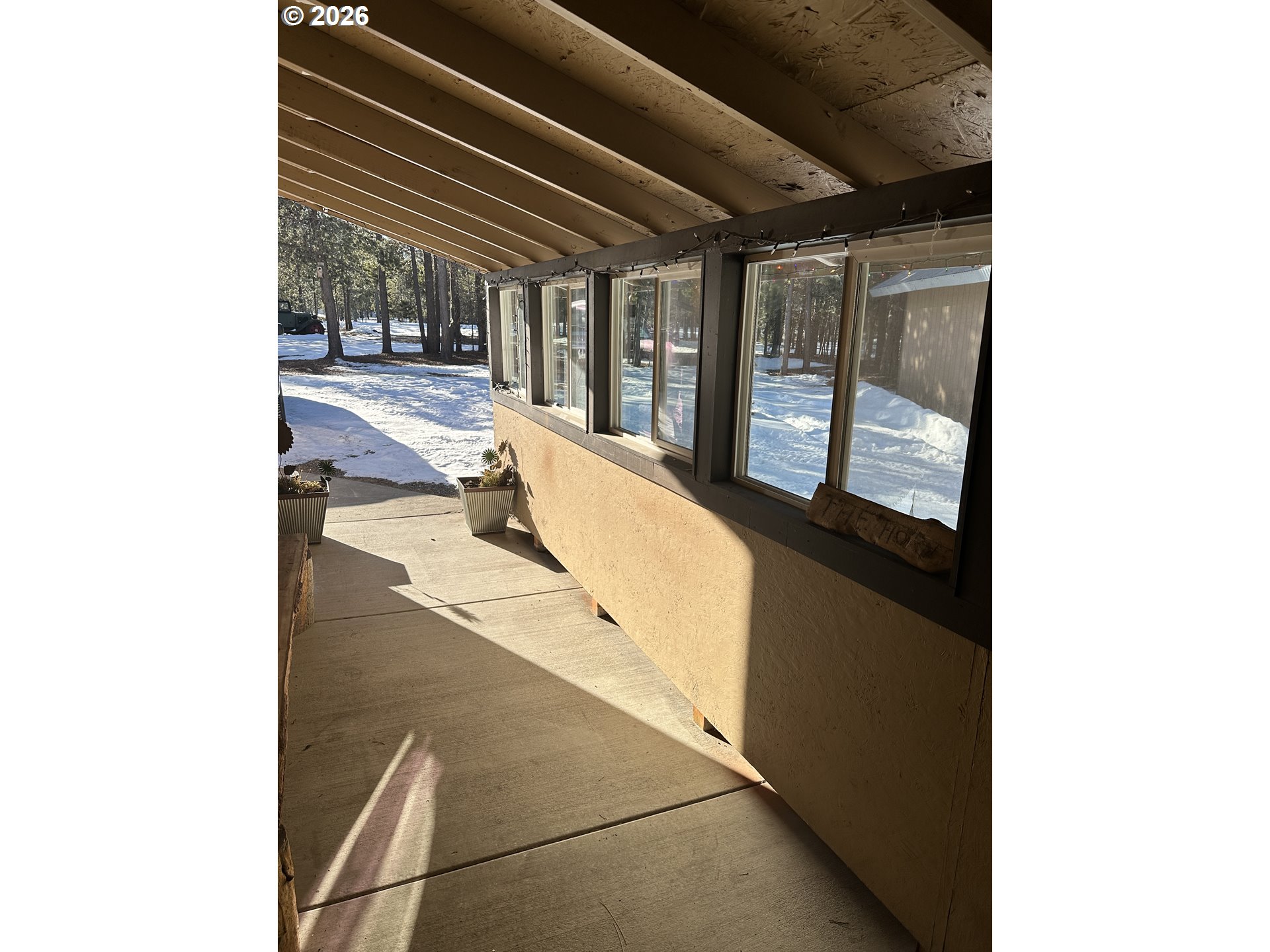 123977 Surveyor Road Crescent Lake, OR 97733 - Photo 4 of 46 a view of a living room with a balcony and large window