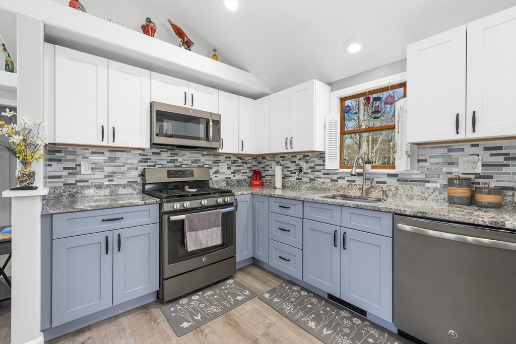 16 Hazelwood Road Dennis, MA 02660 - Photo 14 of 40 a kitchen with granite countertop cabinets stainless steel appliances a sink and a window