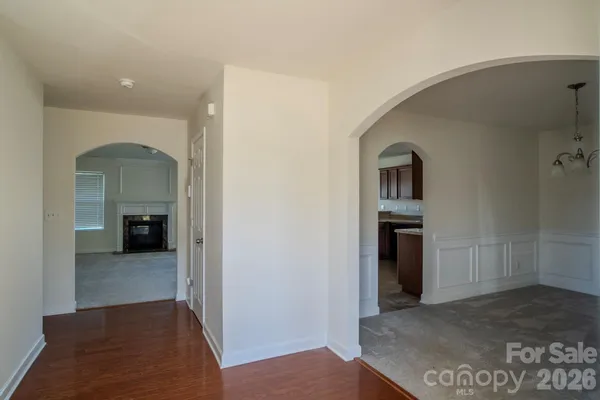a view of a hallway with an entryway and livingroom