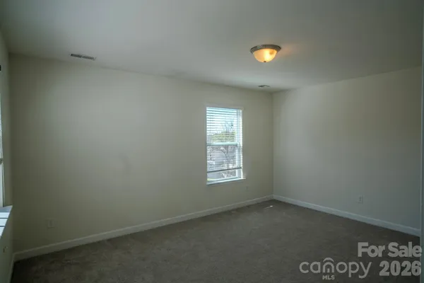 an empty room with windows and yard