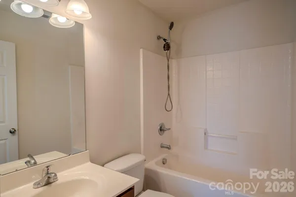 a bathroom with a sink a mirror and a bathtub