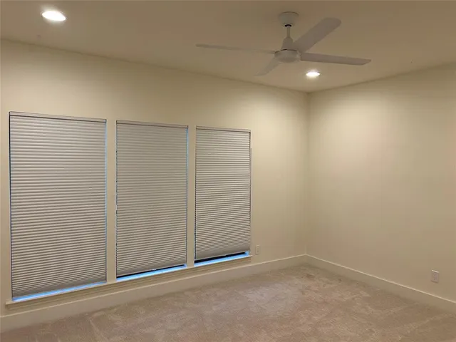 a view of an empty room with a fireplace and a window