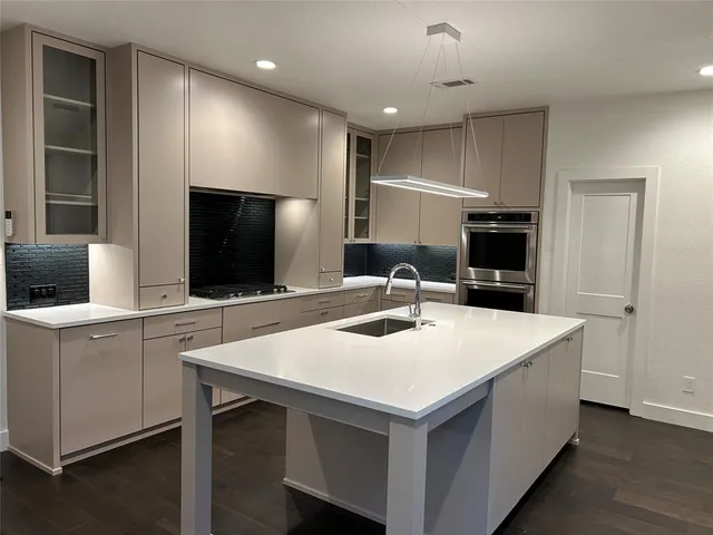 a kitchen with kitchen island a sink and appliances