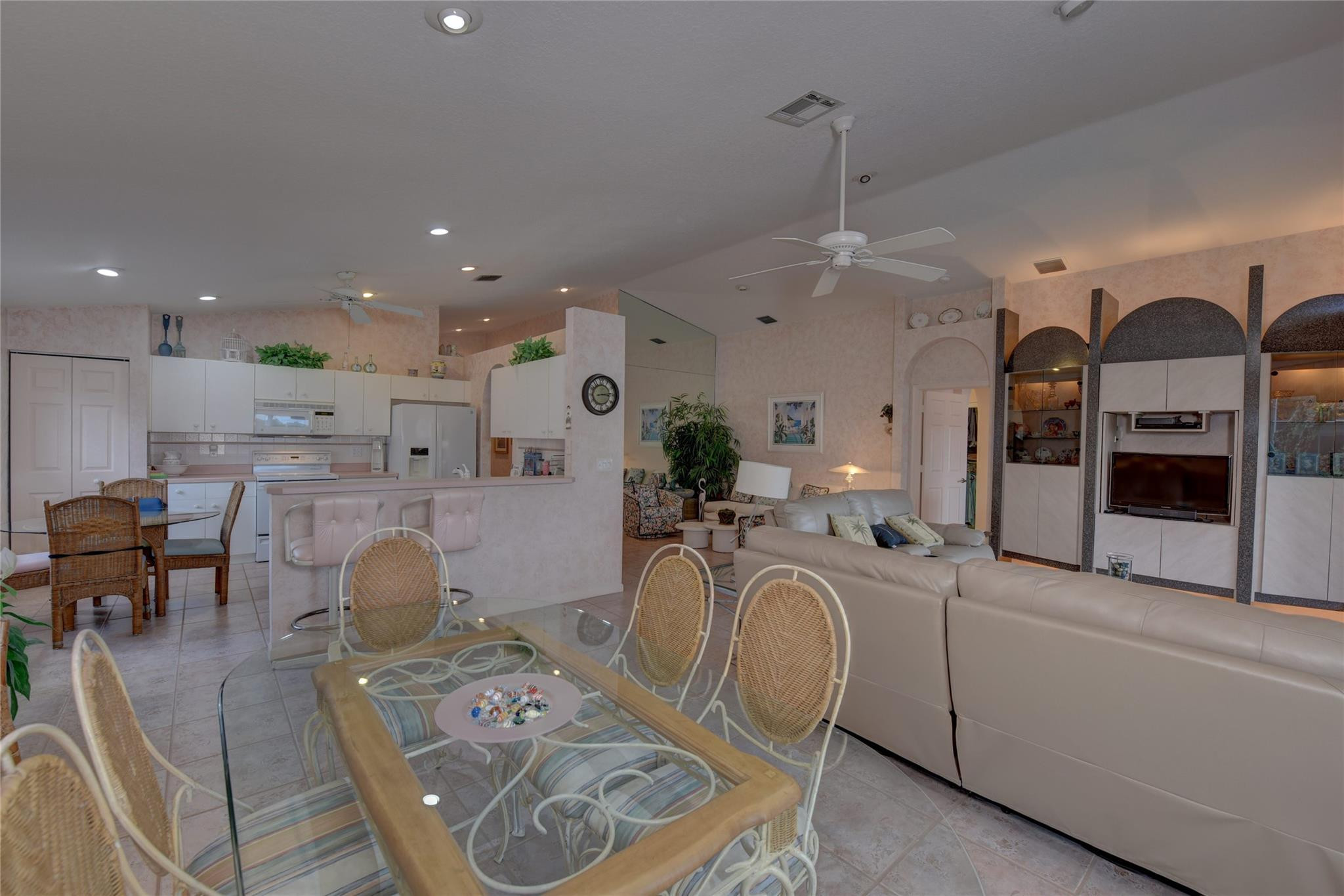 22918 Sterling Lakes Drive Boca Raton, FL 33433 - Photo 21 of 57 a living room with furniture a fireplace and kitchen view
