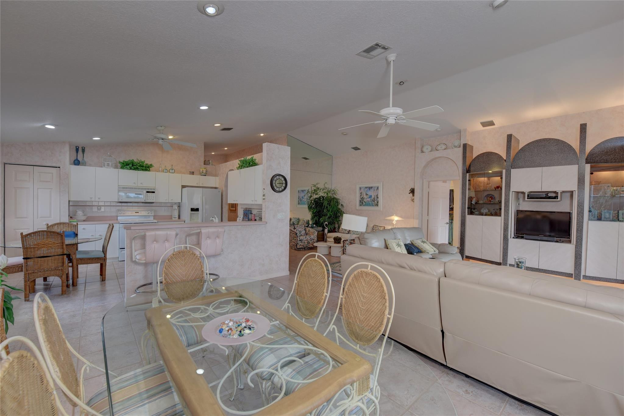 22918 Sterling Lakes Drive Boca Raton, FL 33433 - Photo 22 of 57 a very nice looking open dining room with kitchen island stainless steel appliances furniture a fireplace and a kitchen view