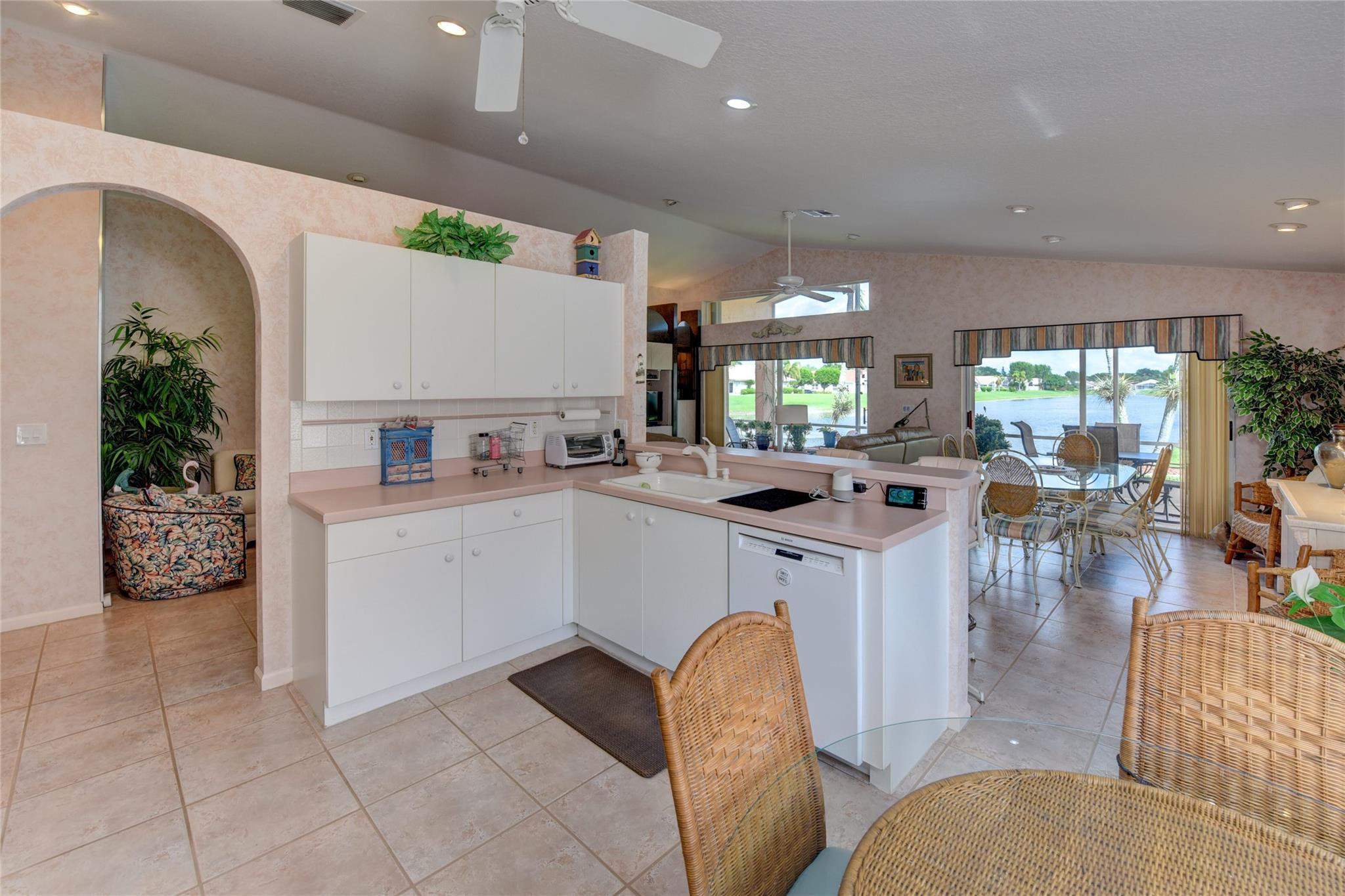 22918 Sterling Lakes Drive Boca Raton, FL 33433 - Photo 26 of 57 a kitchen with a sink refrigerator and cabinets