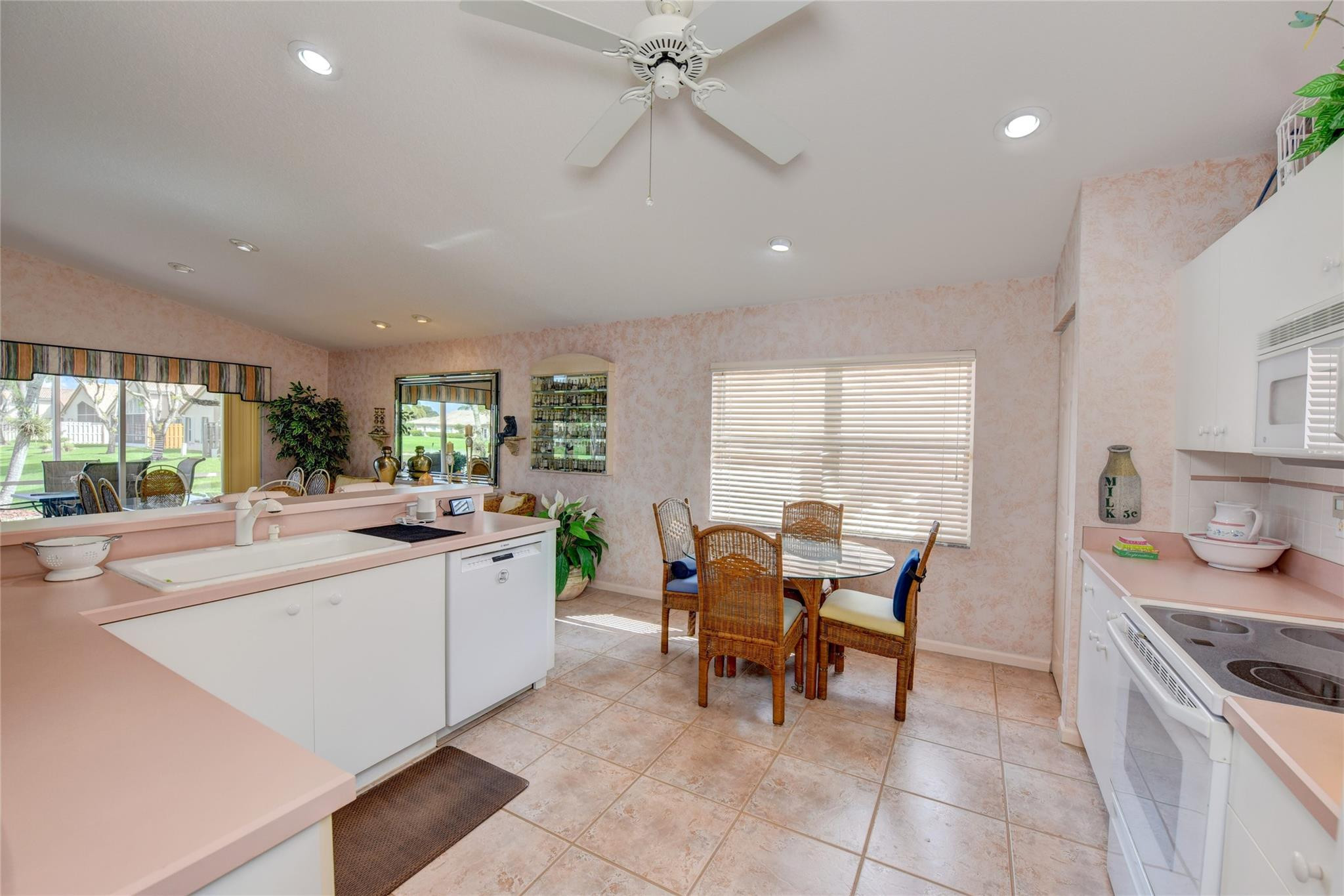 22918 Sterling Lakes Drive Boca Raton, FL 33433 - Photo 28 of 57 a kitchen with granite countertop cabinets and chairs