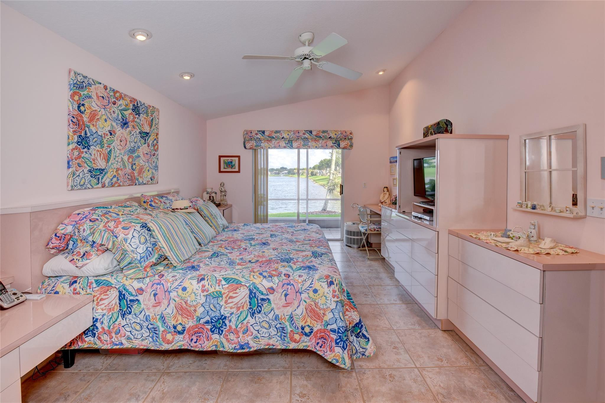 22918 Sterling Lakes Drive Boca Raton, FL 33433 - Photo 30 of 57 a spacious bedroom with a bed and a dresser in it