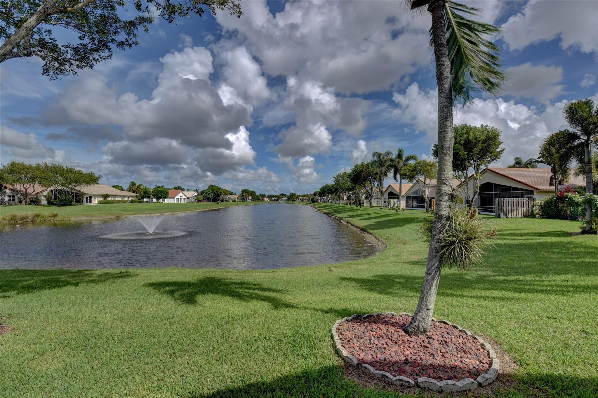 22918 Sterling Lakes Drive Boca Raton, FL 33433 - Photo 3 of 57 a view of a lake with a yard