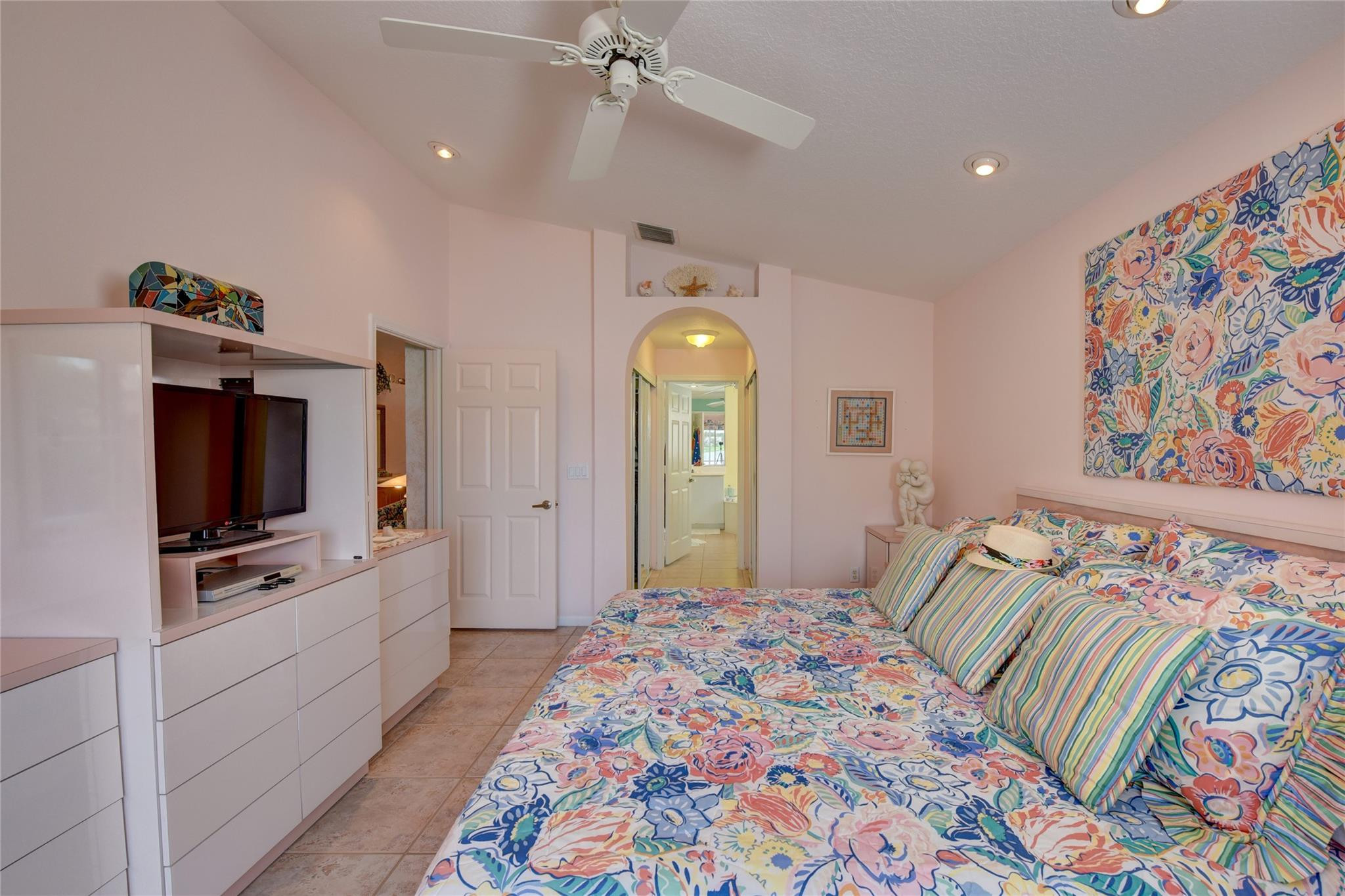 22918 Sterling Lakes Drive Boca Raton, FL 33433 - Photo 31 of 57 a bedroom with a bed and a flat tv screen on the dresser