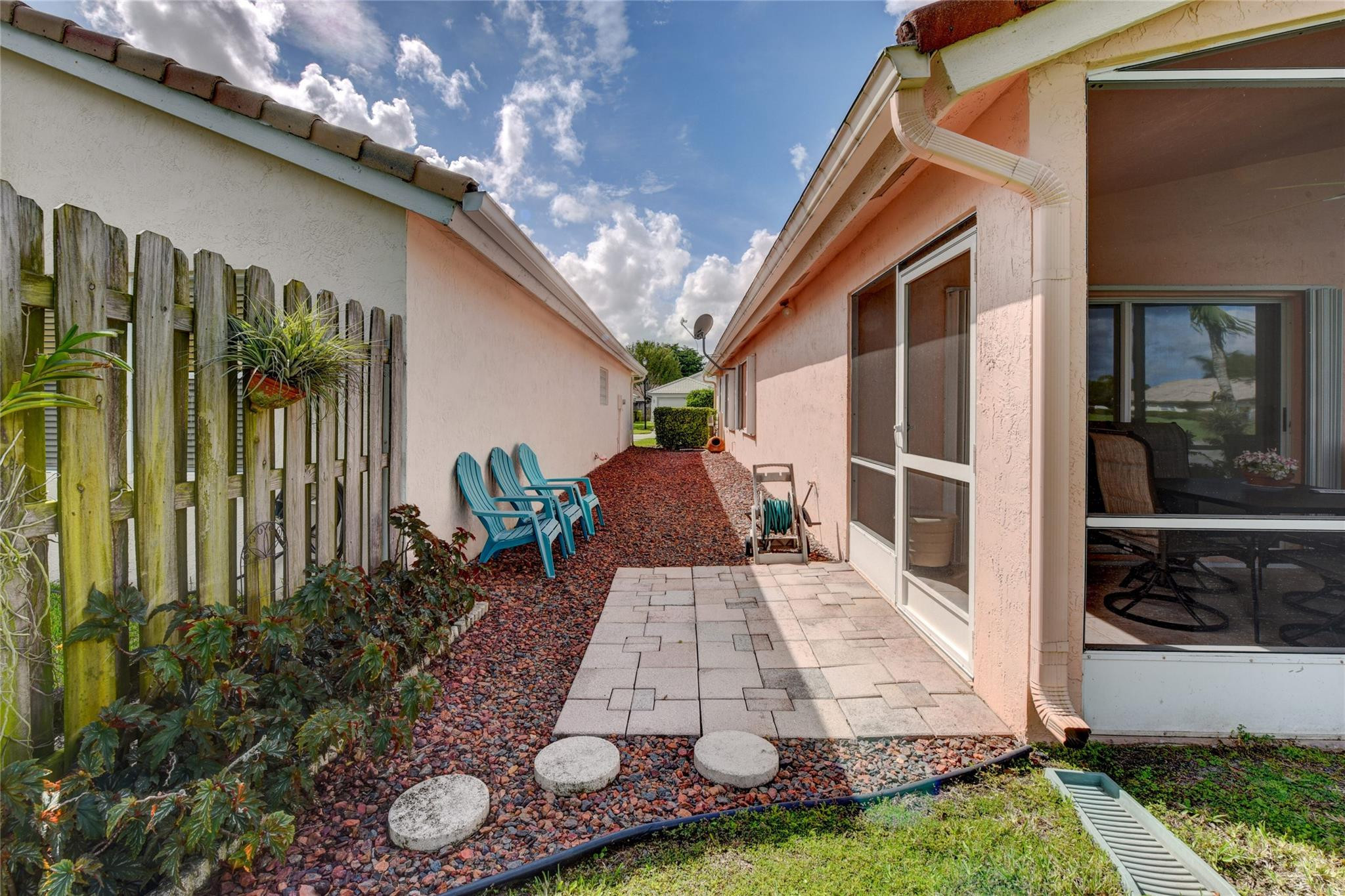 22918 Sterling Lakes Drive Boca Raton, FL 33433 - Photo 7 of 57 a view of a patio with table and chairs potted plants with wooden floor and fence