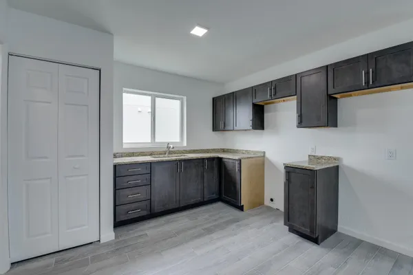 a kitchen with a sink and a stove top oven