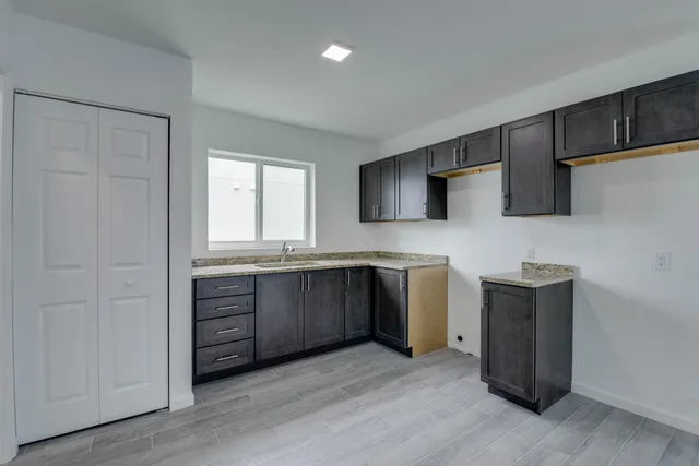 a kitchen with a sink and a stove top oven