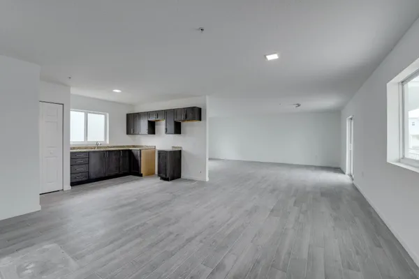 a large room with wooden floor and furniture