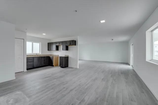 a large room with wooden floor and furniture