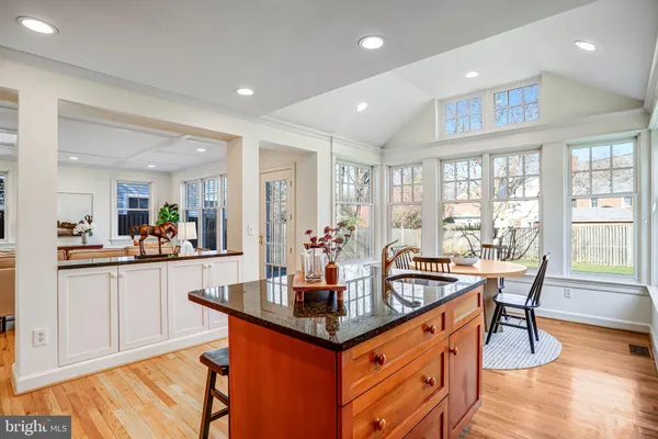a kitchen with granite countertop a sink and cabinets