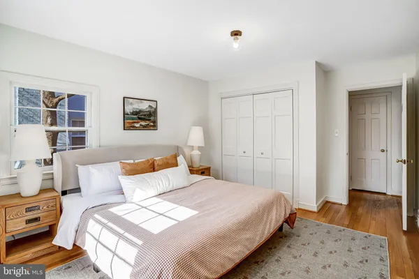 a bedroom with bed and wooden floor