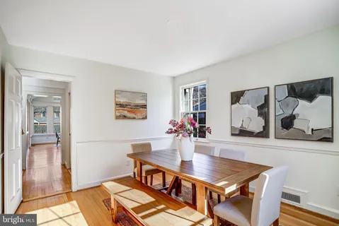 a dining room with furniture and wooden floor