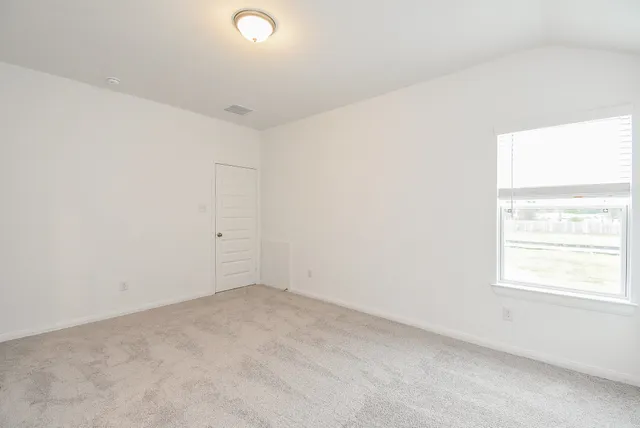 an empty room with closet area