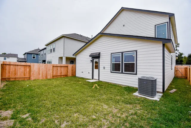 a view of a backyard with wooden fence