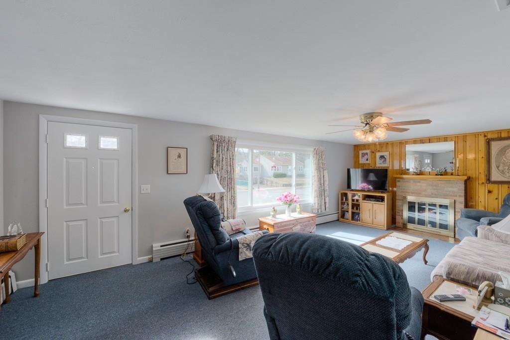 18 Sasur Street Three Rivers, MA 01080 - Photo 5 of 30 a living room with furniture a fireplace and large windows