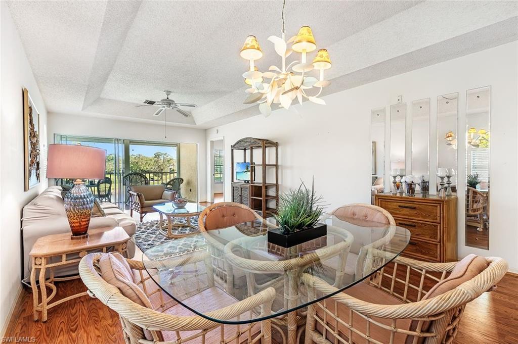 555 Augusta Boulevard, Unit 36 Naples, FL 34113 - Photo 14 of 25 a view of a dining room with furniture a livingroom and chandelier