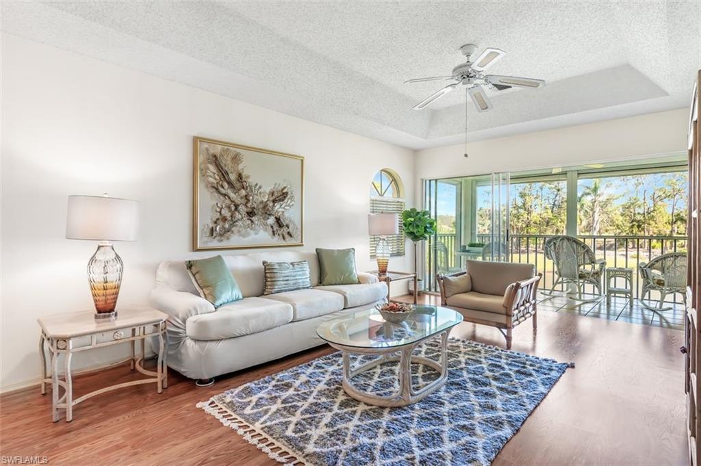 555 Augusta Boulevard, Unit 36 Naples, FL 34113 - Photo 15 of 25 a living room with furniture and a large window