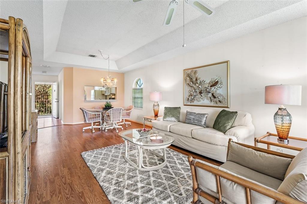 555 Augusta Boulevard, Unit 36 Naples, FL 34113 - Photo 17 of 25 a living room with furniture and wooden floor