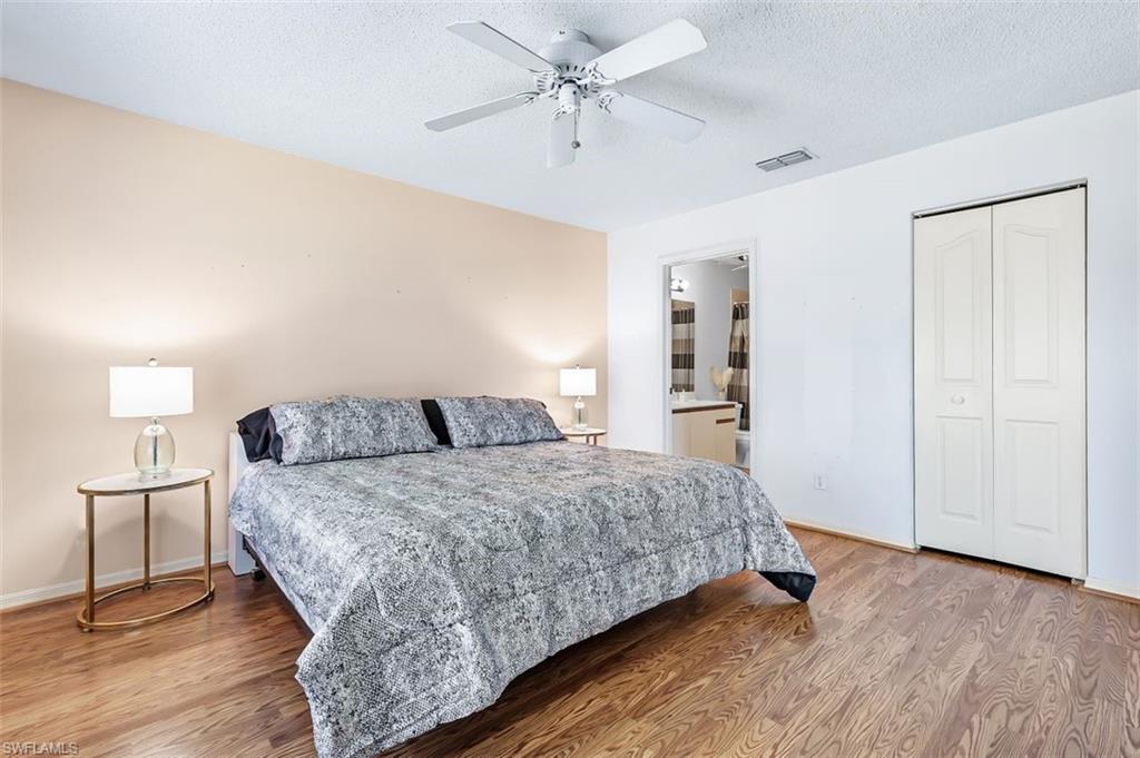 555 Augusta Boulevard, Unit 36 Naples, FL 34113 - Photo 18 of 25 a bedroom with a bed and a chandelier