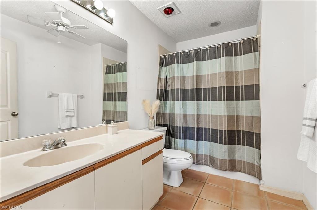 555 Augusta Boulevard, Unit 36 Naples, FL 34113 - Photo 20 of 25 a bathroom with a sink a toilet a shower and a mirror